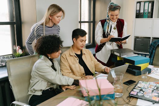 A group of young professionals engaging in a collaborative meeting in a modern office setting.