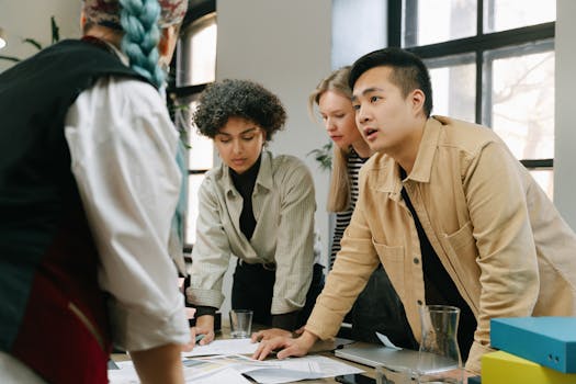 A diverse group of coworkers engaged in a collaborative meeting in a modern office setting.