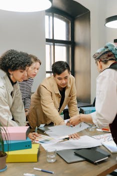 A diverse team engaged in a collaborative meeting in a modern office setting.