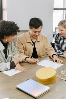 A diverse group of professionals collaborating on a project in a modern office setting.