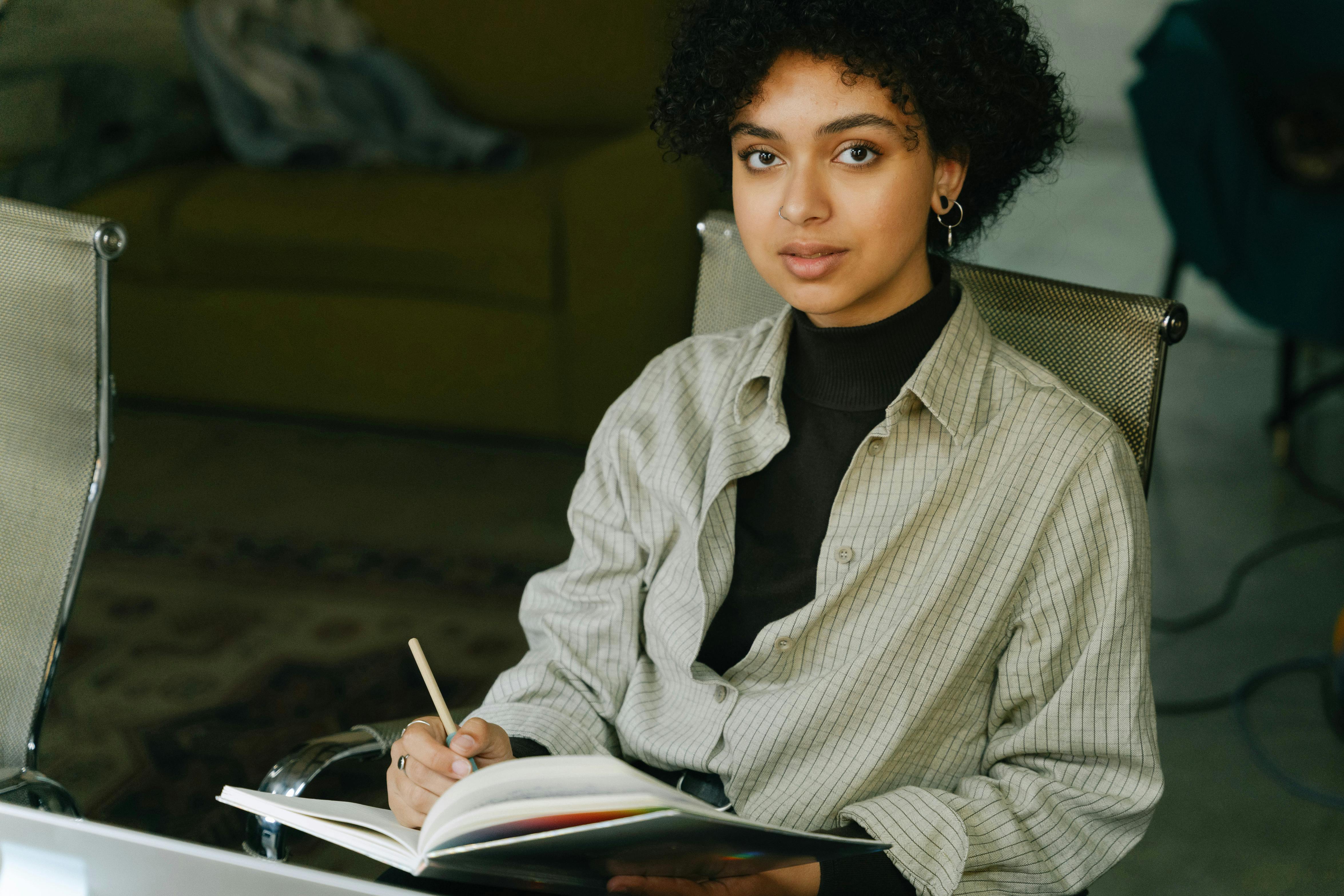 A Woman Writing in the Notebook · Free Stock Photo