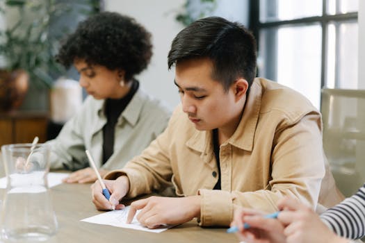 Diverse group collaborates in an office, jotting plans in a focused meeting.