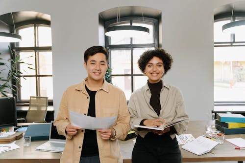 A Man Holding a Document Standing Beside a Woman