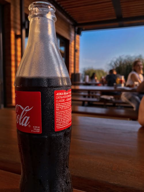 Free A Bottle of Soda on a Wooden Table Stock Photo