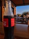 Coca Cola Bottle on Brown Wooden Table