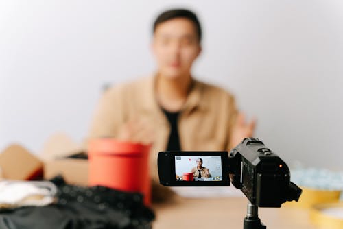 Free A Man Sitting in Front of a Video Camera Stock Photo