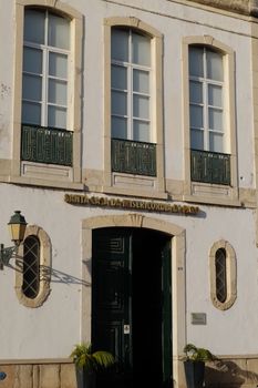 Elegant facade featuring classic architecture with glass panels and a wooden door entrance.