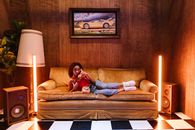 A Woman Lying on the Couch while on the Telephone