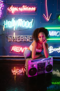 Young woman in a neon-lit room with a vintage boombox, embodying vibrant nightlife and urban culture.