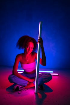 Creative portrait of a young woman with neon lights in a studio setting, exuding a vibrant and artistic vibe.