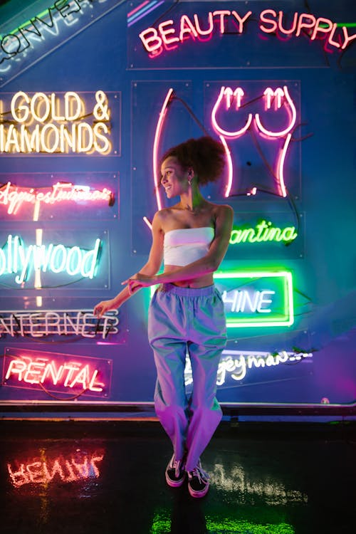 A Woman Standing Near the Neon Signs · Free Stock Photo