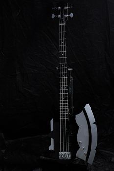 Electric guitar with unique axe-like design on dark background, perfect for rock music themes.