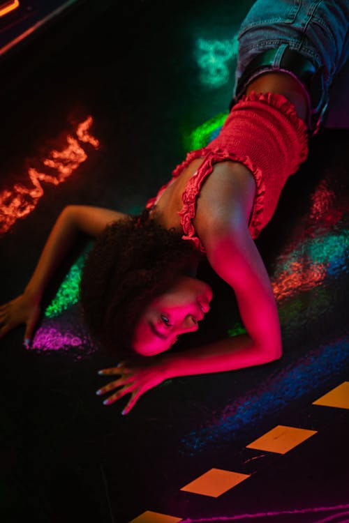 Free Overhead Shot of a Girl with Curly Hair Lying on the Floor Stock Photo