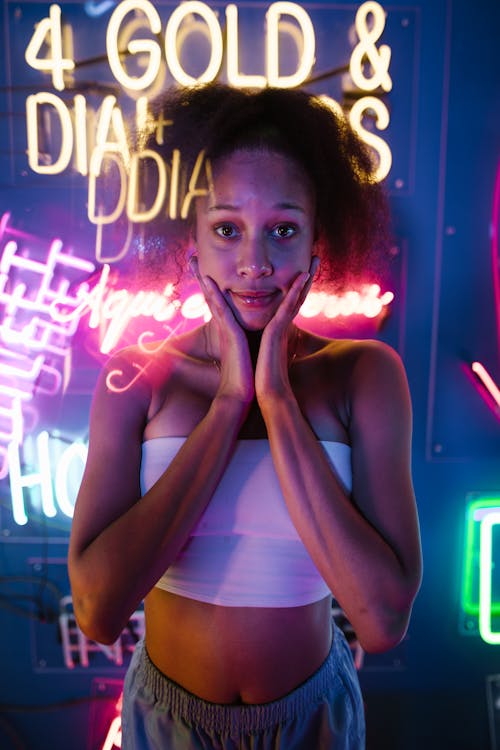 A Woman in Crop Top with Her Hands on Cheeks