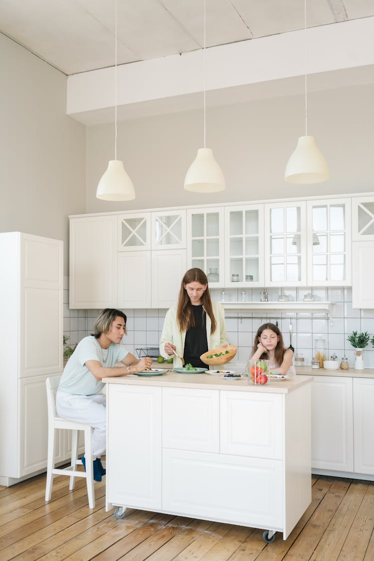 People Eating Together At The Kitchen