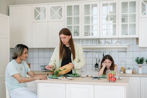 Free A diverse family enjoying a healthy breakfast together in a stylish kitchen. Stock Photo