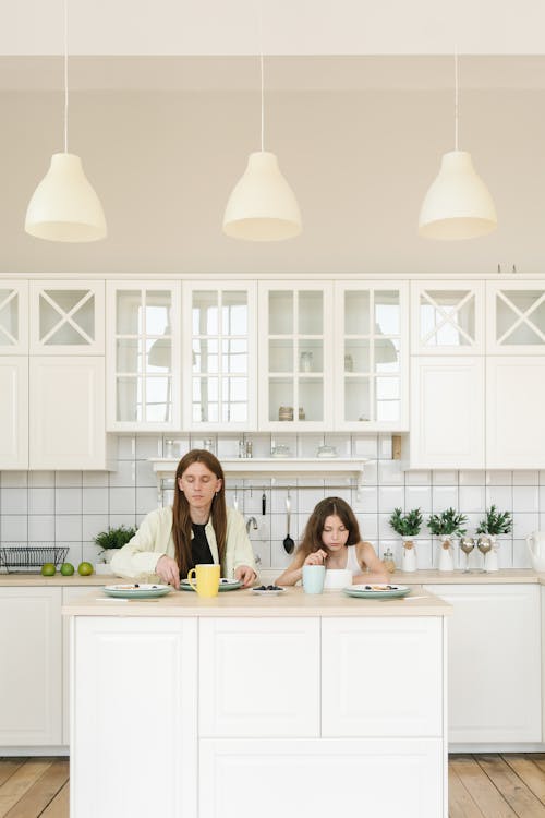 Free A Father and Daughter Eating Breakfast by the Kitchen Counter Stock Photo