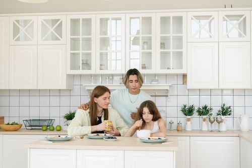 Free A diverse family having breakfast together in a bright, modern kitchen. Stock Photo