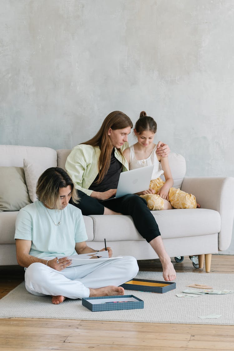 Parents With Their Daughter In A Living Room 