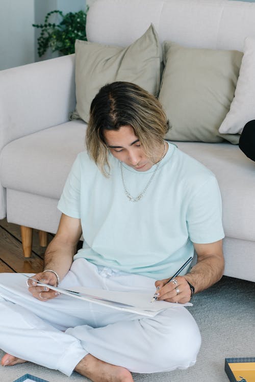 A Man Drawing on a Sketch Pad 