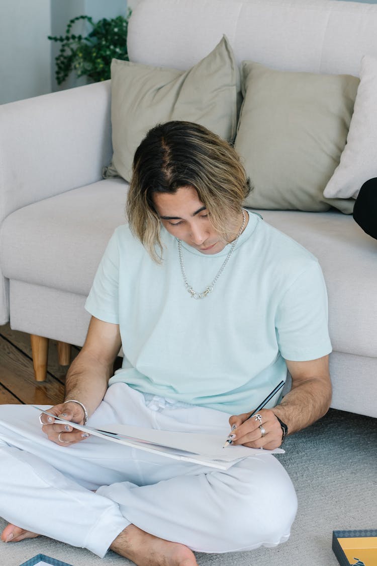 A Man Drawing On A Sketch Pad 