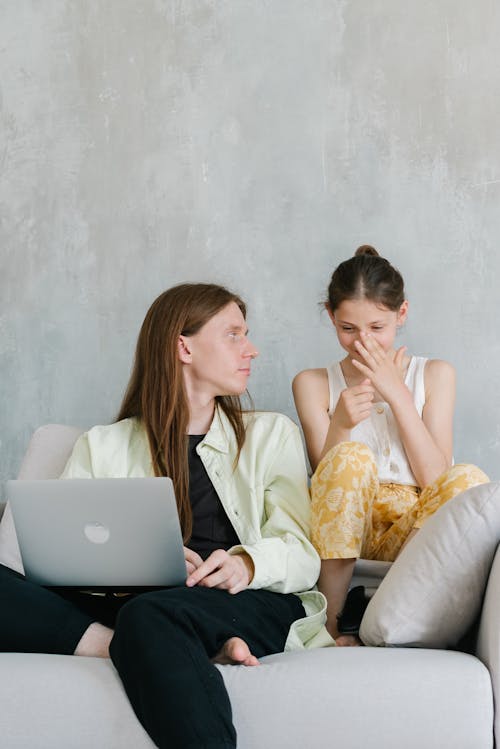 Free Man and Child Sitting on a Couch Stock Photo