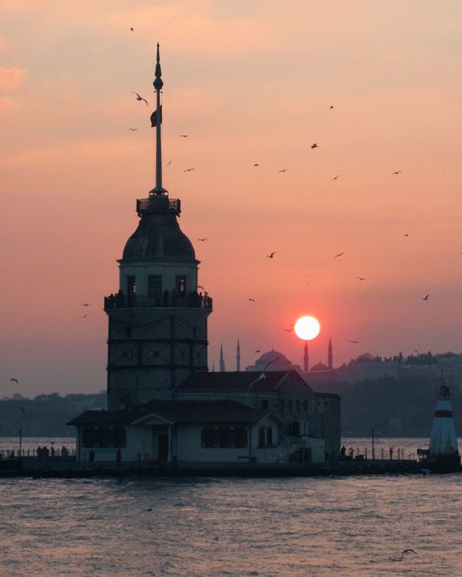 Majestic silhouette of Maiden's Tower against a vibrant sunset in Istanbul, Turkey.