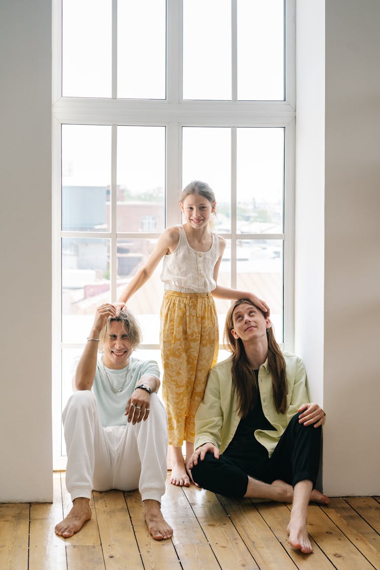 A Family Posing By The Window