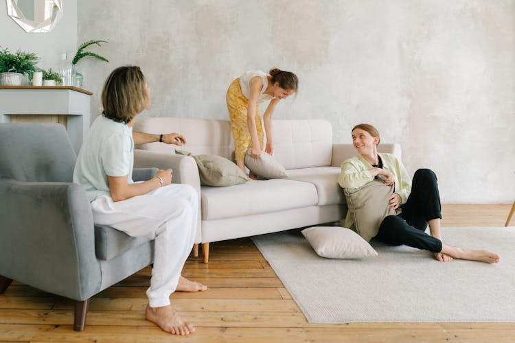 Woman In Yellow Sleeveless Dress Sitting On White Couch