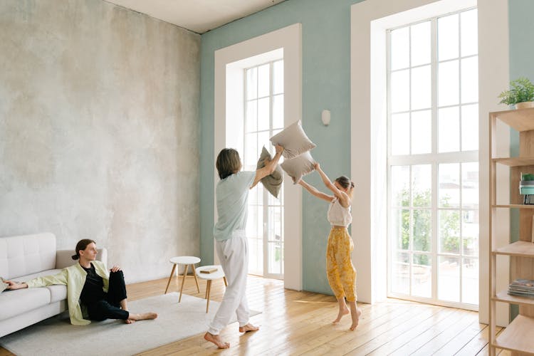 A Family Playing Pillow Fight At Home