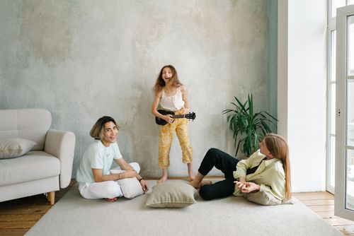 Free A joyful family scene indoors with playing and relaxation, creating a warm, happy atmosphere. Stock Photo