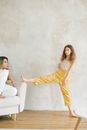 Woman in Yellow Dress Sitting on White Couch