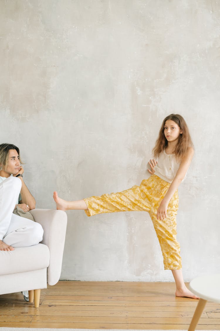 Mother Looking At A Daughter With Foot On The Sofa