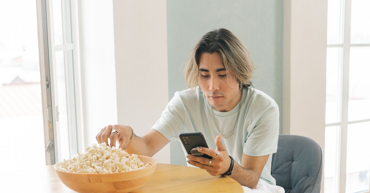 hbo max logo on phone screen with popcorn