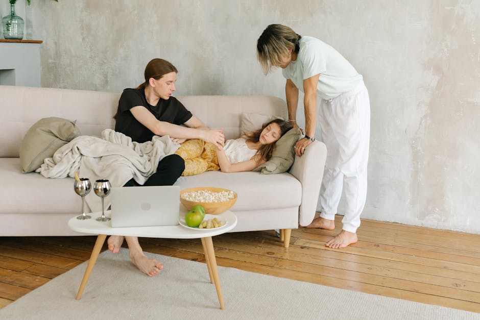 Family relaxing on a sofa with snacks and drinks in a cozy living room vibe.