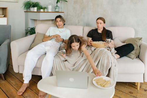 Free A Happy Family Sitting on the Couch while Having Conversation Stock Photo