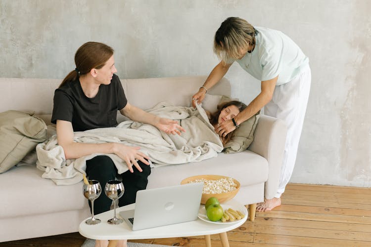 Parents With Their Daughter In A Living Room 