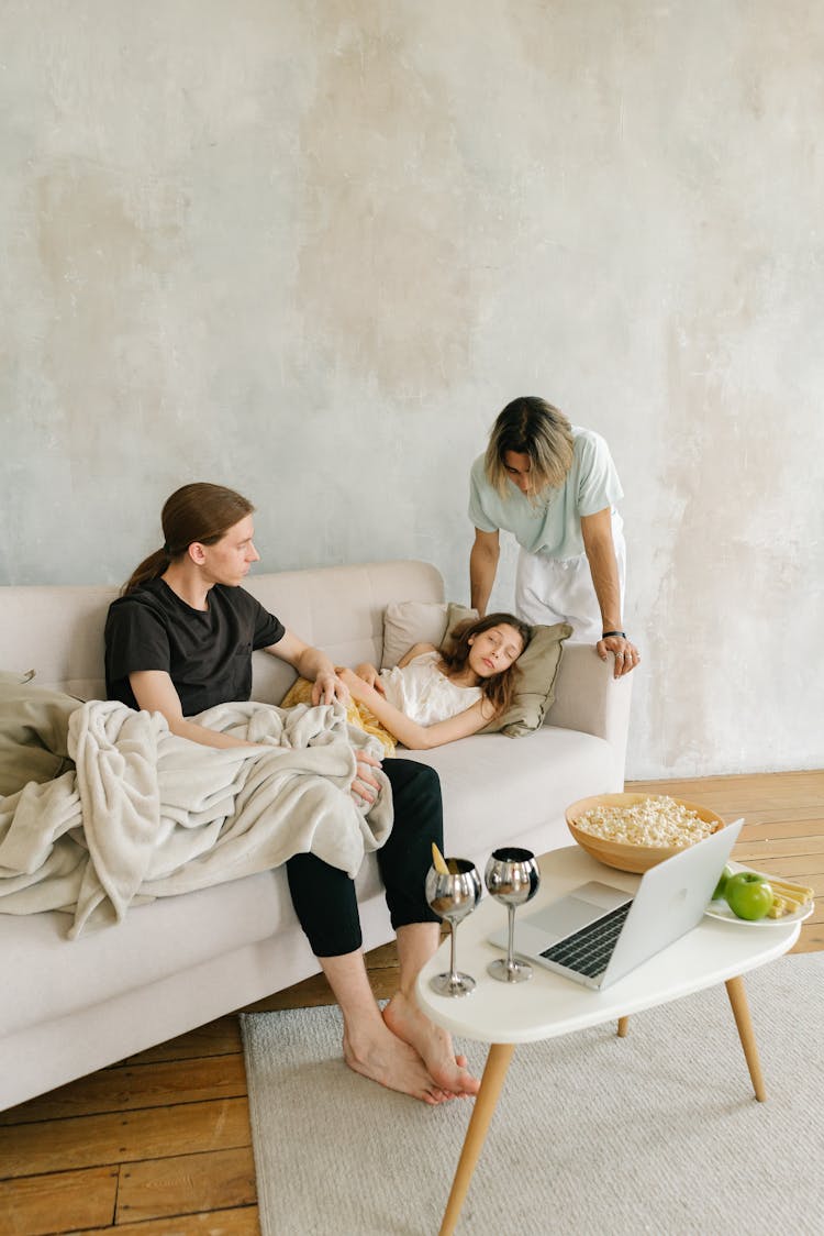 Parents With Their Daughter In A Living Room 