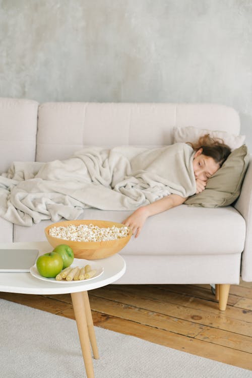 Free A Girl Resting on the Sofa Stock Photo