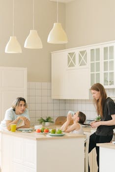 Family enjoying a relaxed morning together in a bright, modern kitchen setting.