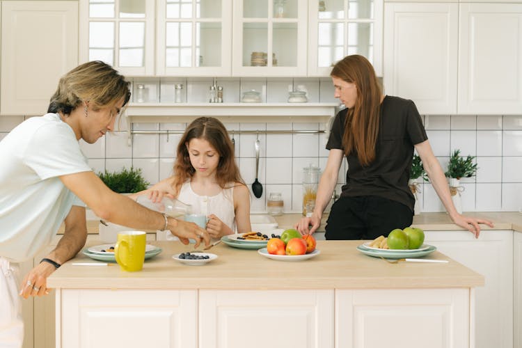 Parents With Daughter In Kitchen