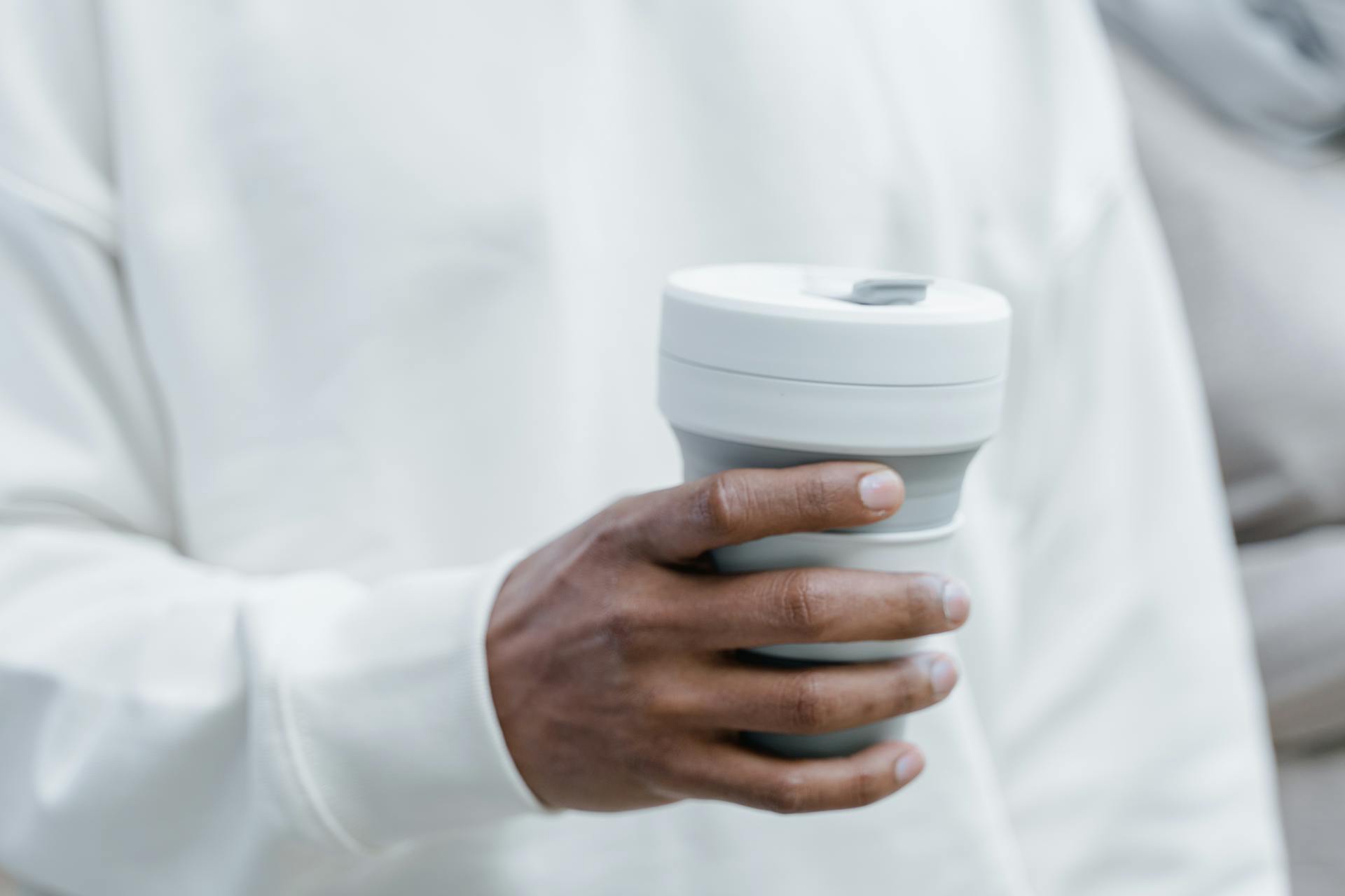 Person Holding a Stojo Collapsible Cup