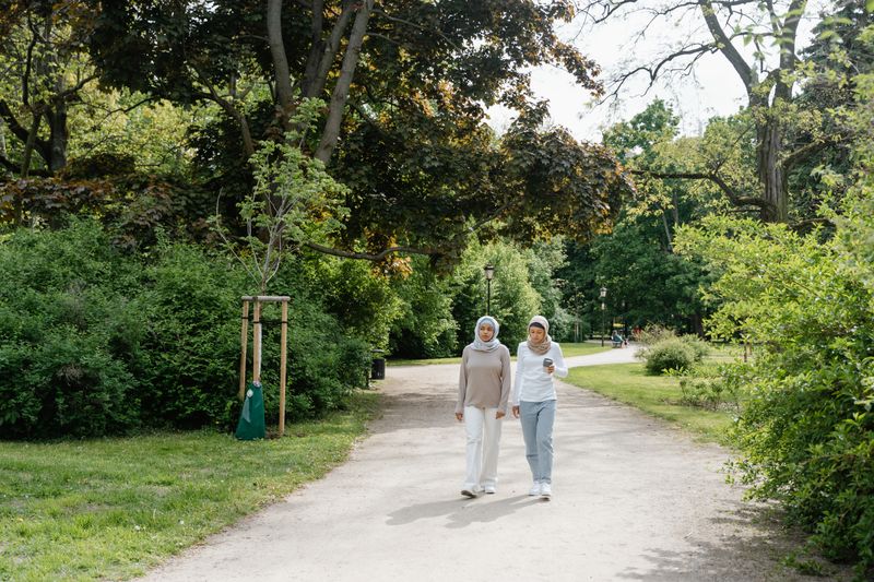 two coworkers from different departments walking and chatting