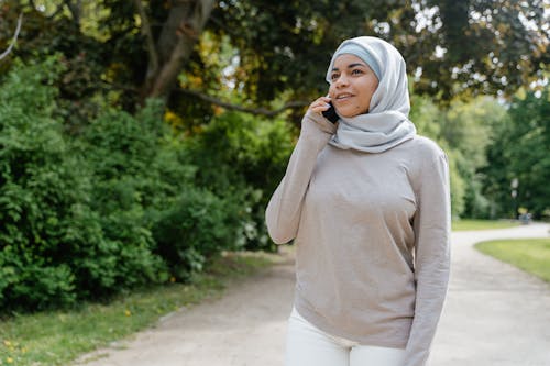 A Woman in Hijab Talking on Her Cellphone