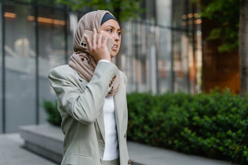 A Woman in Business Attire Using a Cellphone