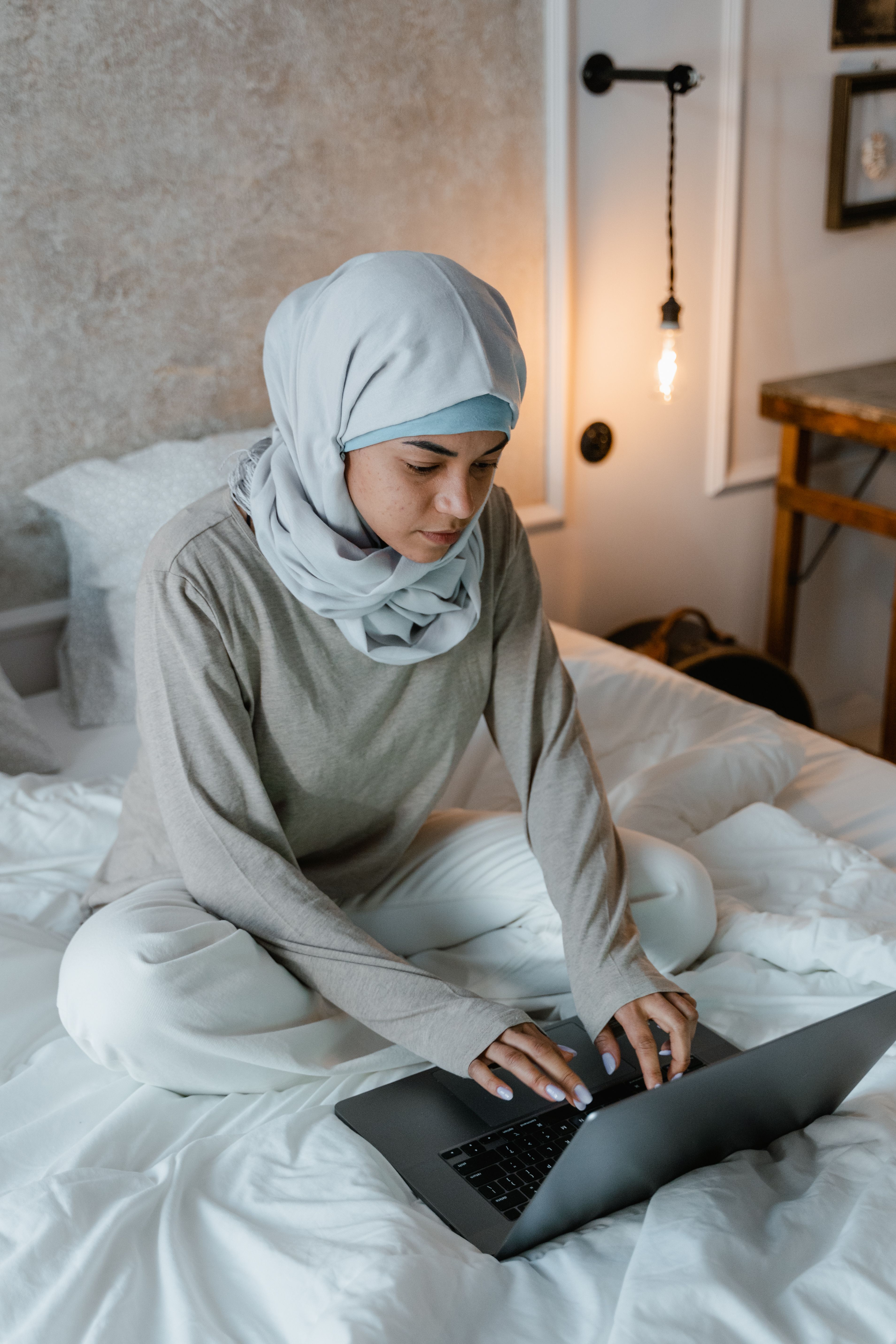 Woman in White Hijab Sitting on Bed · Free Stock Photo