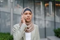 Woman in White Coat and Blue Hijab