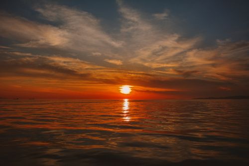 Free Stunning sunset view over tranquil sea in Turkey with vibrant orange and blue hues. Stock Photo