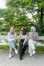 2 Women Sitting on White Bench