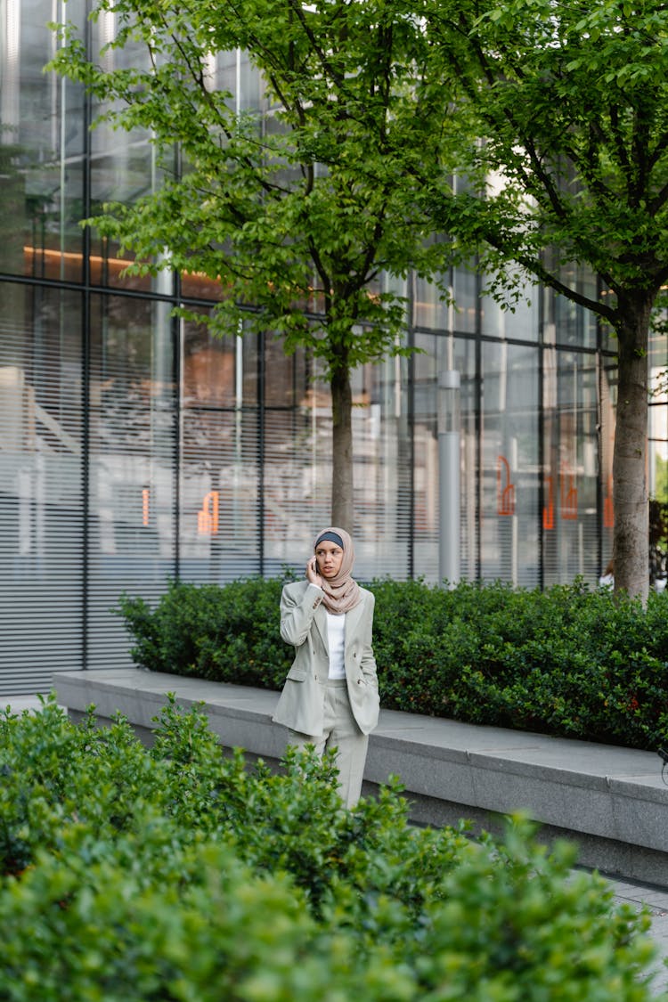 Woman In Corporate Attire Talking On The Phone Outside The Building